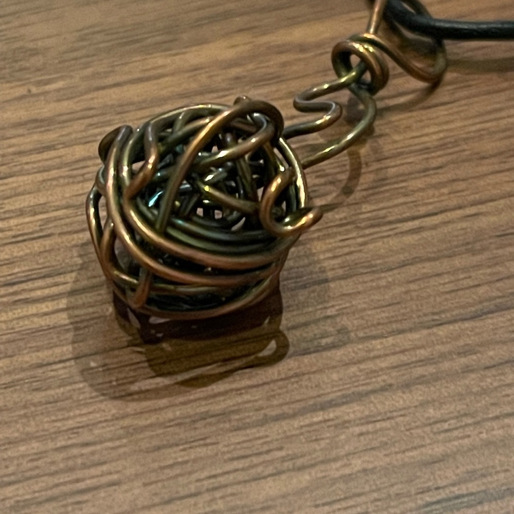 Mixed metal wire sculptural necklace on waxed cotton string